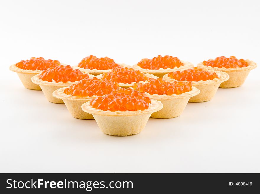 Tartlets with red caviar isolated on a white background. Tartlets with red caviar isolated on a white background