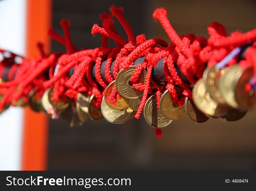 Red rope and coin,which in a temple in tokyo japan
