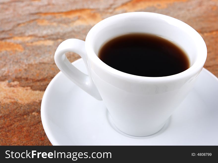 White cup of coffee over color background