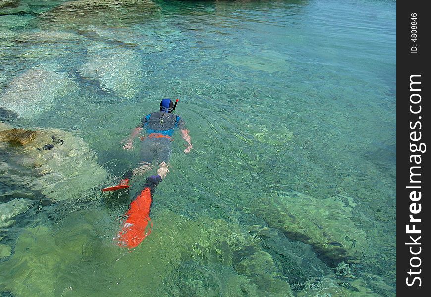 Man snorkeling in crystal azure water. Man snorkeling in crystal azure water