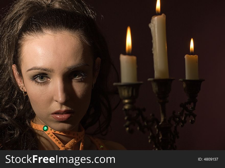 The girl with candles on a dark background