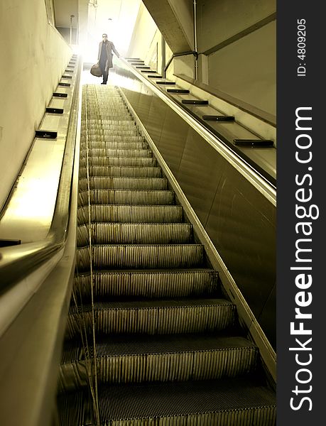 A escalator and a man. A escalator and a man