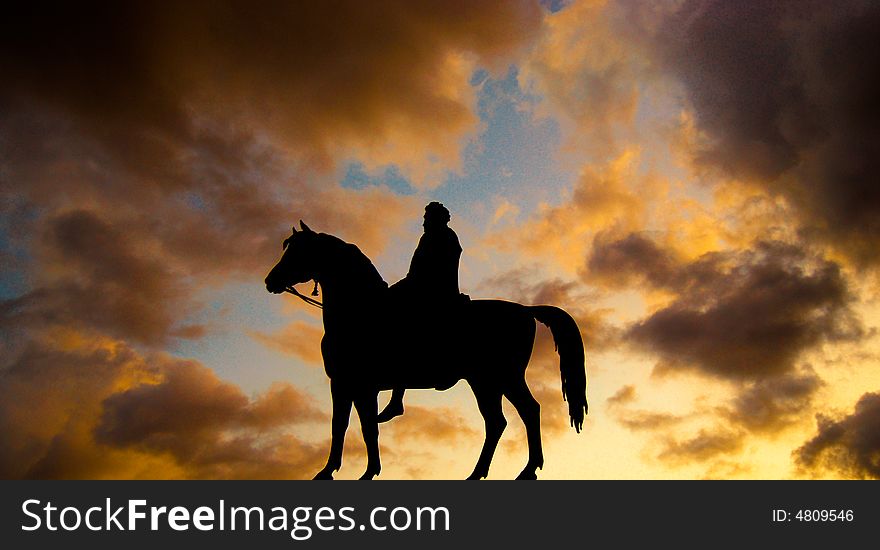 A silhouette of a statue on a sky at dusk backround. A silhouette of a statue on a sky at dusk backround
