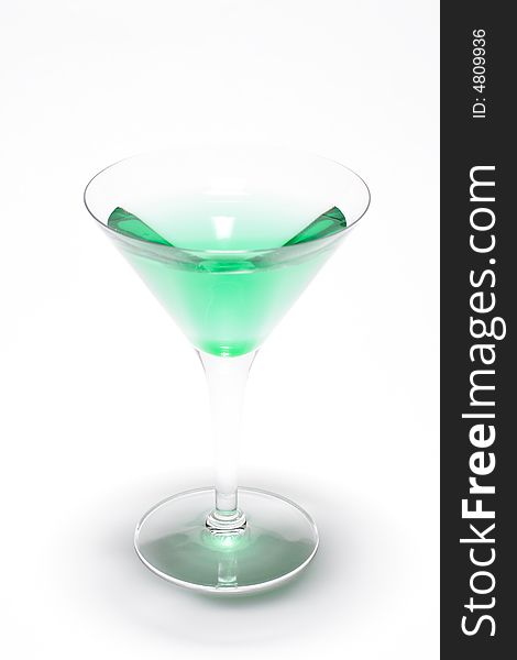 A glass with a green liquid, mint, inside. A glass with a green liquid, mint, inside.