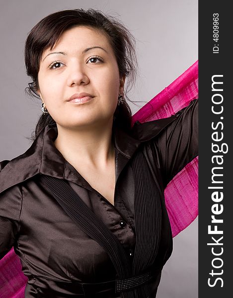 Multi-ethnic girl in studio on grey background.