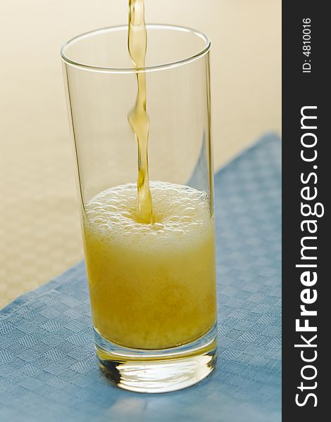 Pouring beer into glass on the table