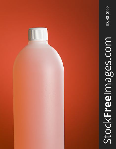 Pink bottle filled with chemical over red background. Pink bottle filled with chemical over red background