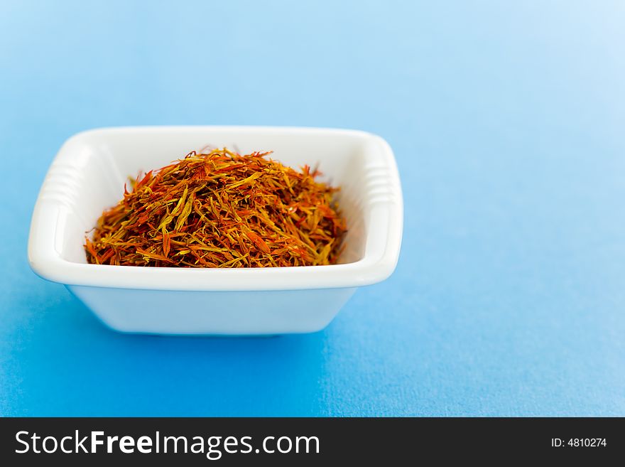 Vase of Saffron over a blue background