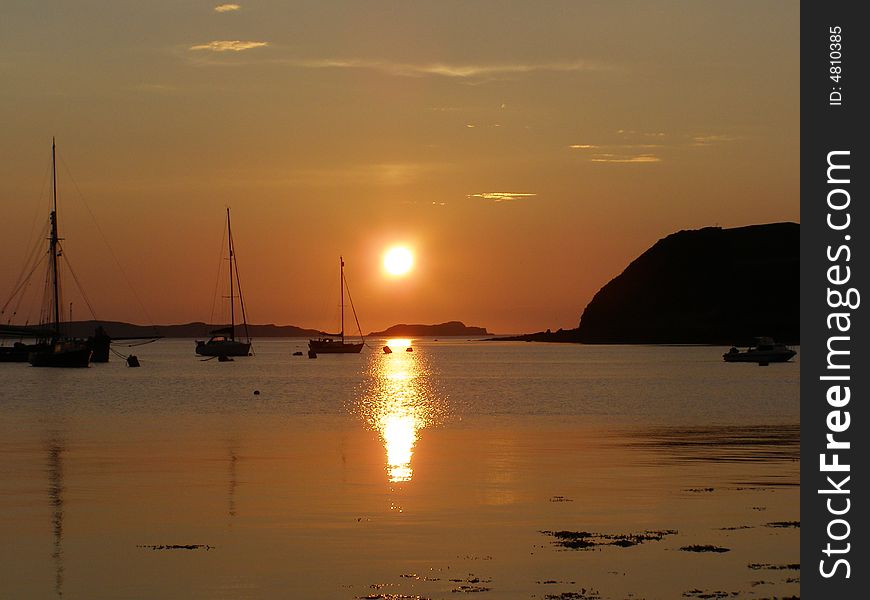 The sun sets behind the Western Isles, seen from the little harbour at Stein, Waternish, on the Isle of Skye. The sun sets behind the Western Isles, seen from the little harbour at Stein, Waternish, on the Isle of Skye.