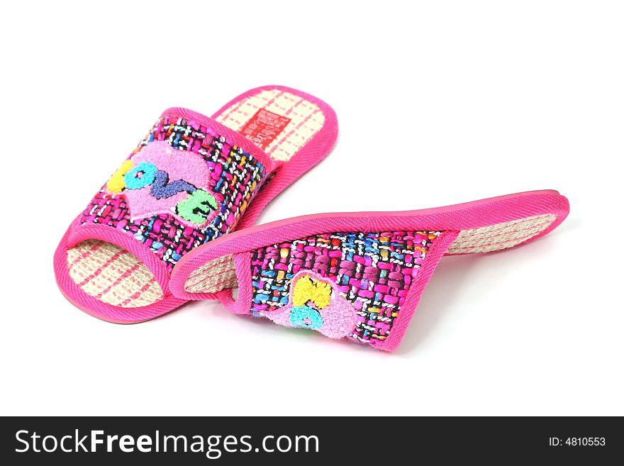 Multi-coloured slippers with heart on white background