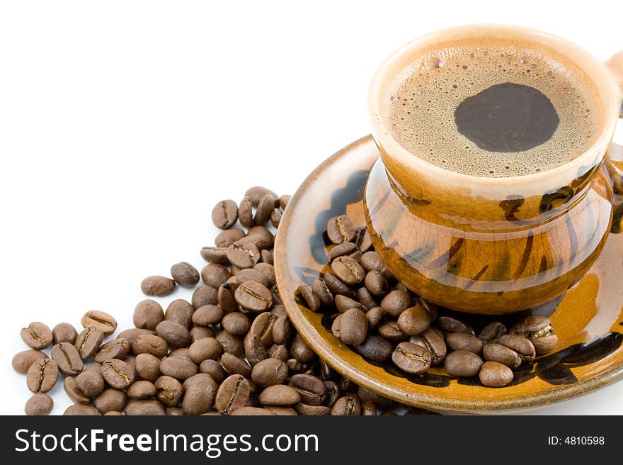Coffee beans and black coffee in a cup isolated on a white background