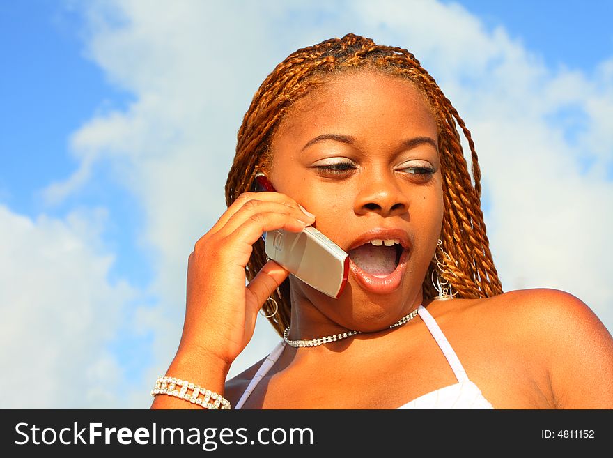 Woman on the phone expressing a shocked look. Woman on the phone expressing a shocked look