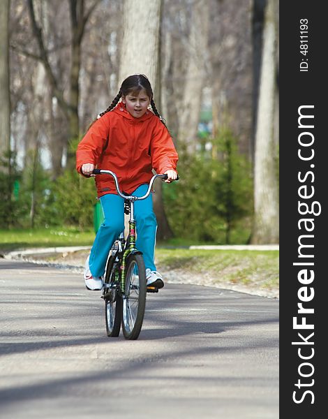 The girl-teenager on park on a bicycle (2)