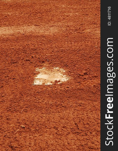 This is a photo of a home plate needing to be dust off.
