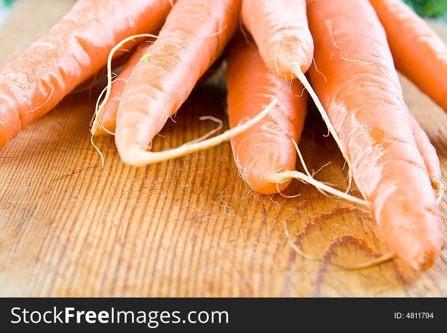 Fresh carrots on a wooden board