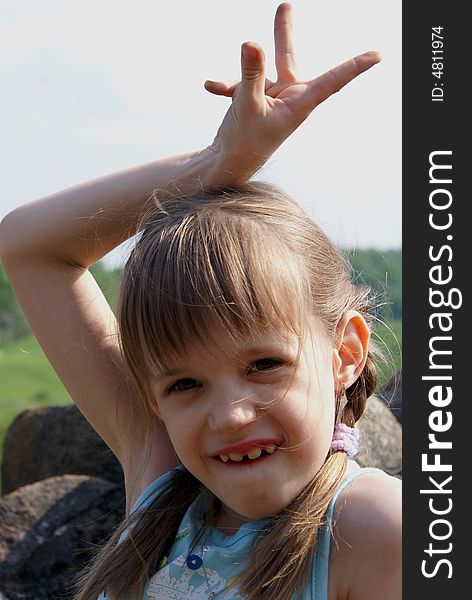 Young girl showing victory sign. Young girl showing victory sign