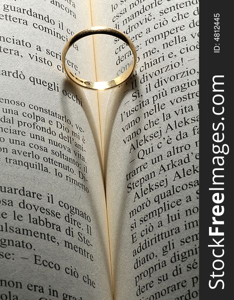 Gold ring shadow over the book. Gold ring shadow over the book