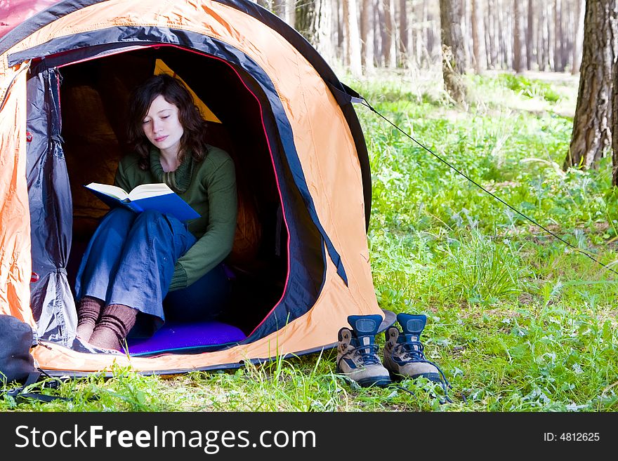 Young woman reading in the middle of the forest. Young woman reading in the middle of the forest