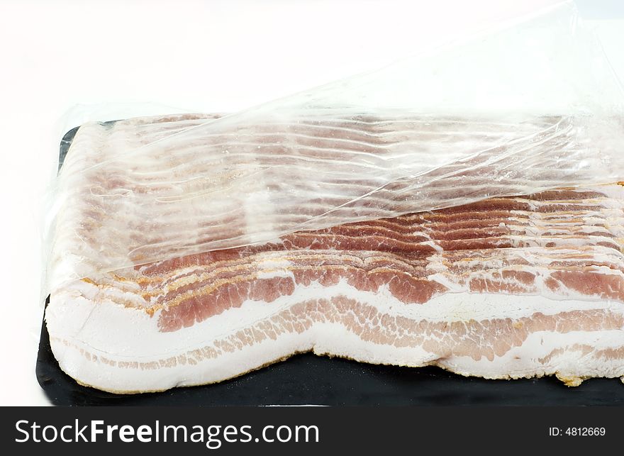 Slices of bacon in a plastic pack. Slices of bacon in a plastic pack
