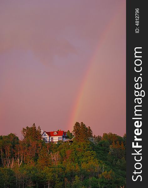 A beautiful red house under rainbow. A beautiful red house under rainbow