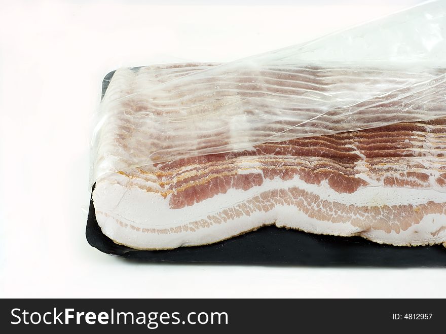 Slices of bacon in a plastic pack. Slices of bacon in a plastic pack..