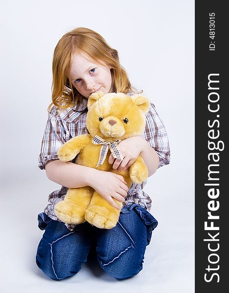 Happy girl is taking care of her teddy bear