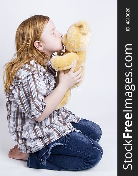 Happy girl is taking care of her teddy bear