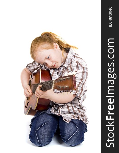 Little girl playing on a guitar