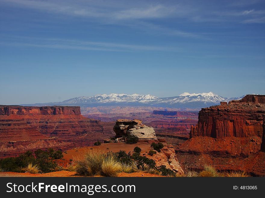 View of the red rock formations in Canyonlands National Park with blue skyï¿½s and clouds. View of the red rock formations in Canyonlands National Park with blue skyï¿½s and clouds