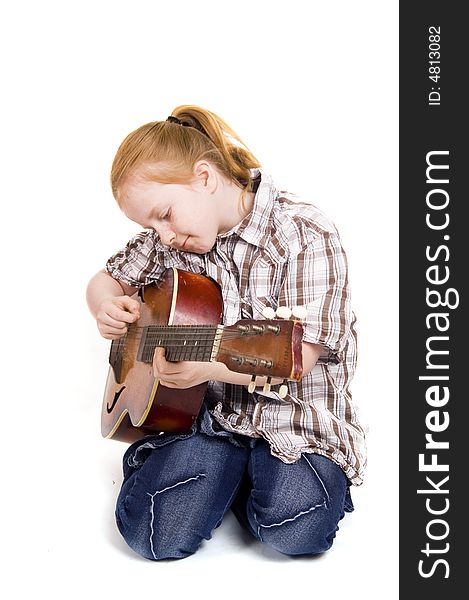 Little girl playing on a guitar