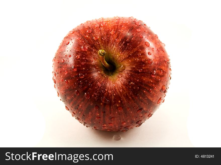 Red fresh apple with waterdrops isolated on white