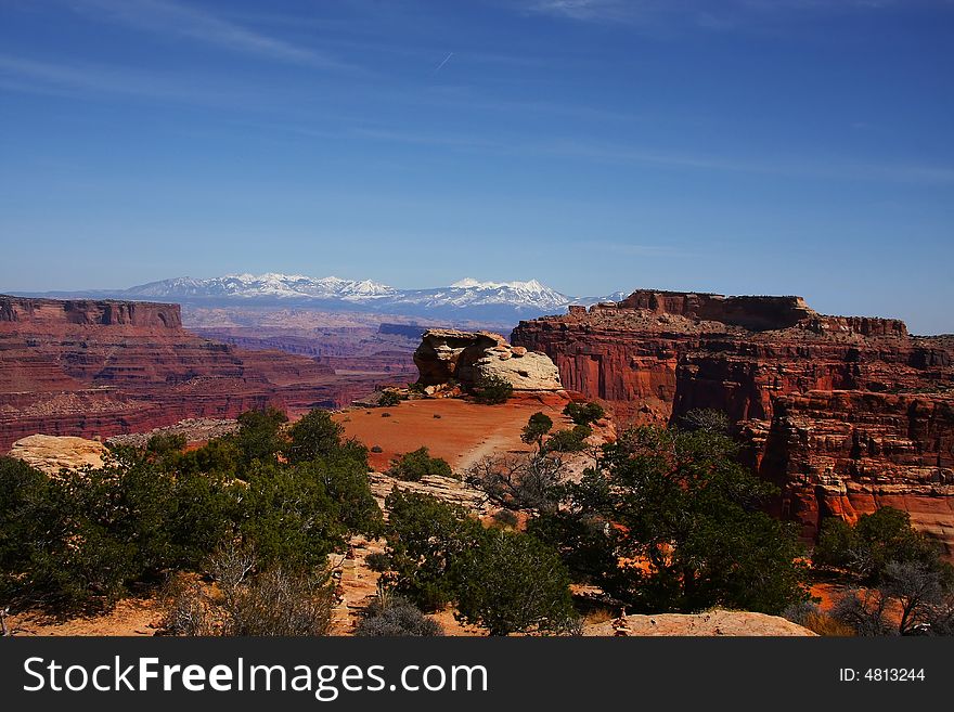 View of the red rock formations in Canyonlands National Park with blue skyï¿½s and clouds. View of the red rock formations in Canyonlands National Park with blue skyï¿½s and clouds