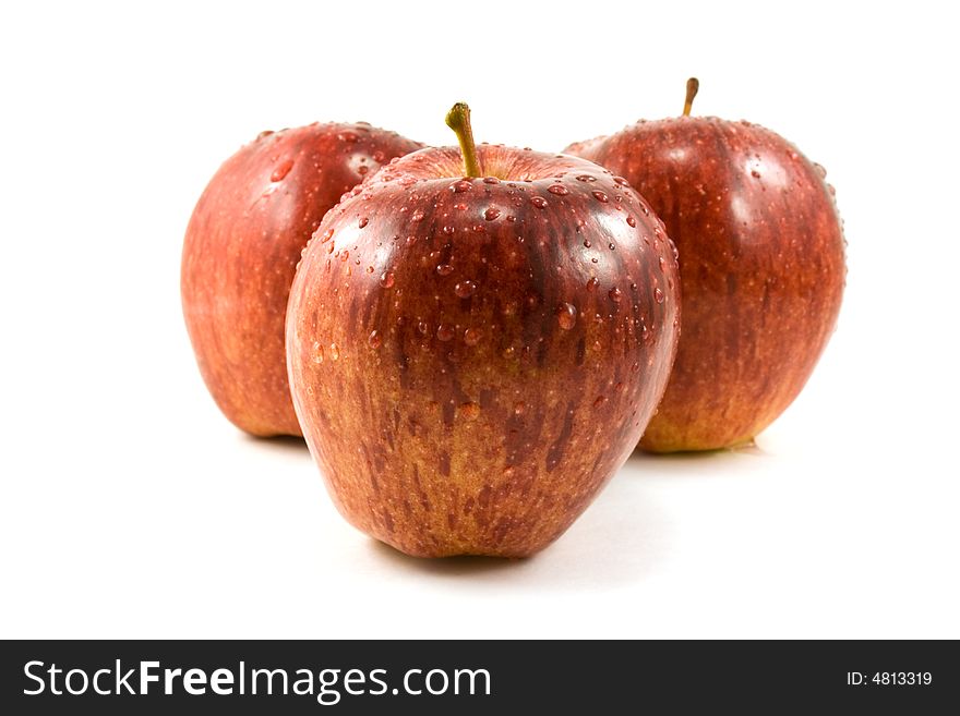 Three red apples with waterdrops isolated on white