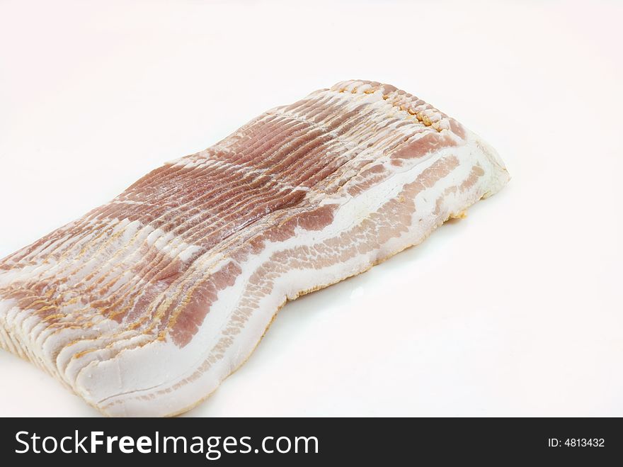 Slices of smoked pork bacon on white background. Slices of smoked pork bacon on white background