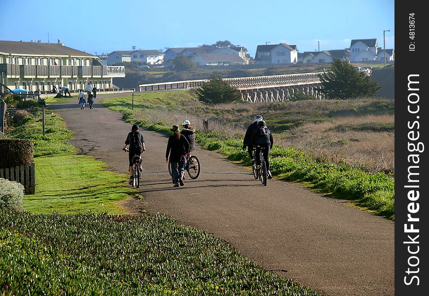 People using a nature path for walking, jogging, and biking. People using a nature path for walking, jogging, and biking