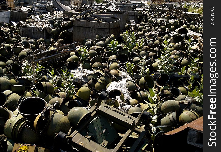 Surplus US Army steel helmets in junkyard. Surplus US Army steel helmets in junkyard