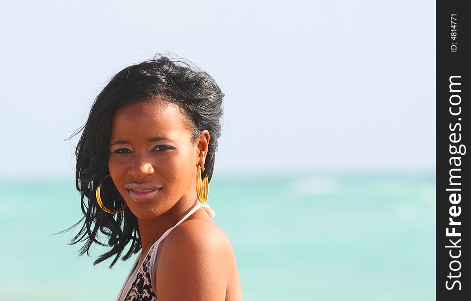 Attractive woman headshot with horizon over the ocean in background.