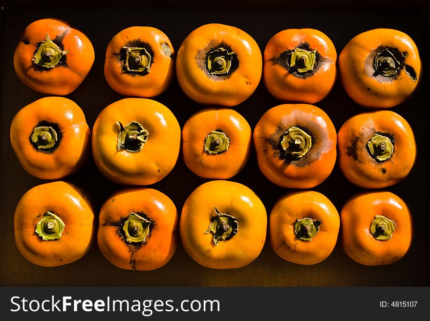 Group of persimmon fruits arranged in rows and columns. Group of persimmon fruits arranged in rows and columns