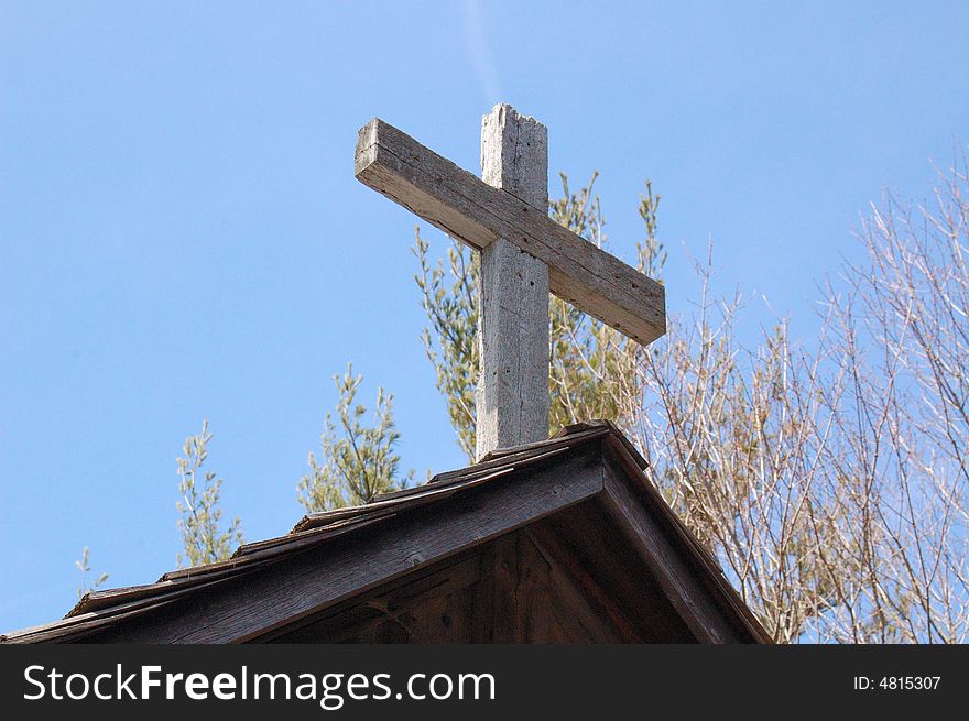 An image of a cross on top of an old wooden church. An image of a cross on top of an old wooden church.