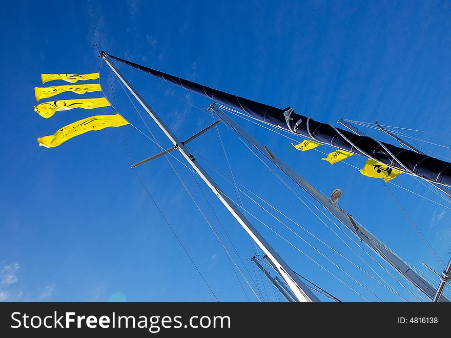 Flags on a Sailboat Mast Anchored at the Marina. Flags on a Sailboat Mast Anchored at the Marina