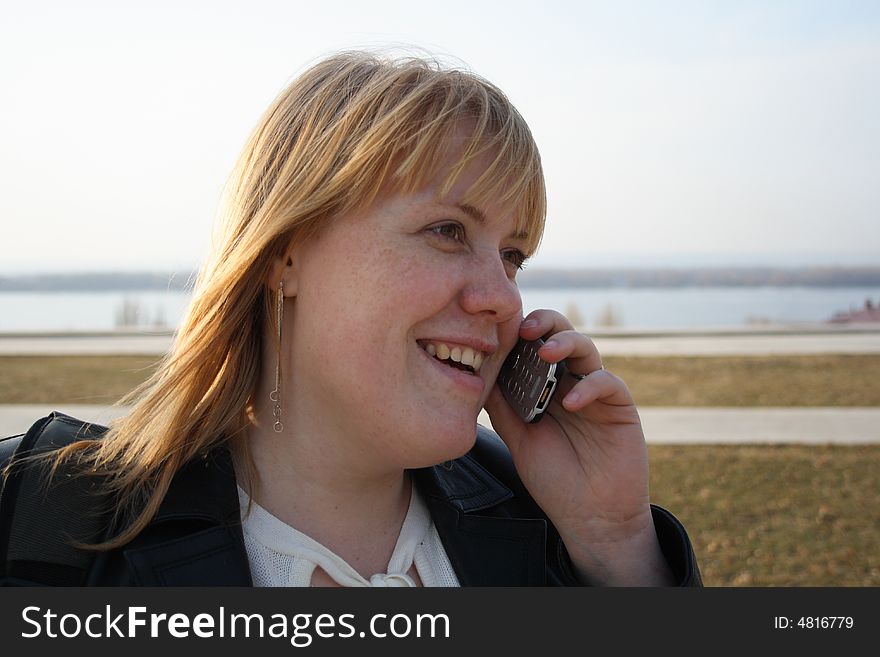 Pretty young girl talking on cell phone outdoor. Pretty young girl talking on cell phone outdoor