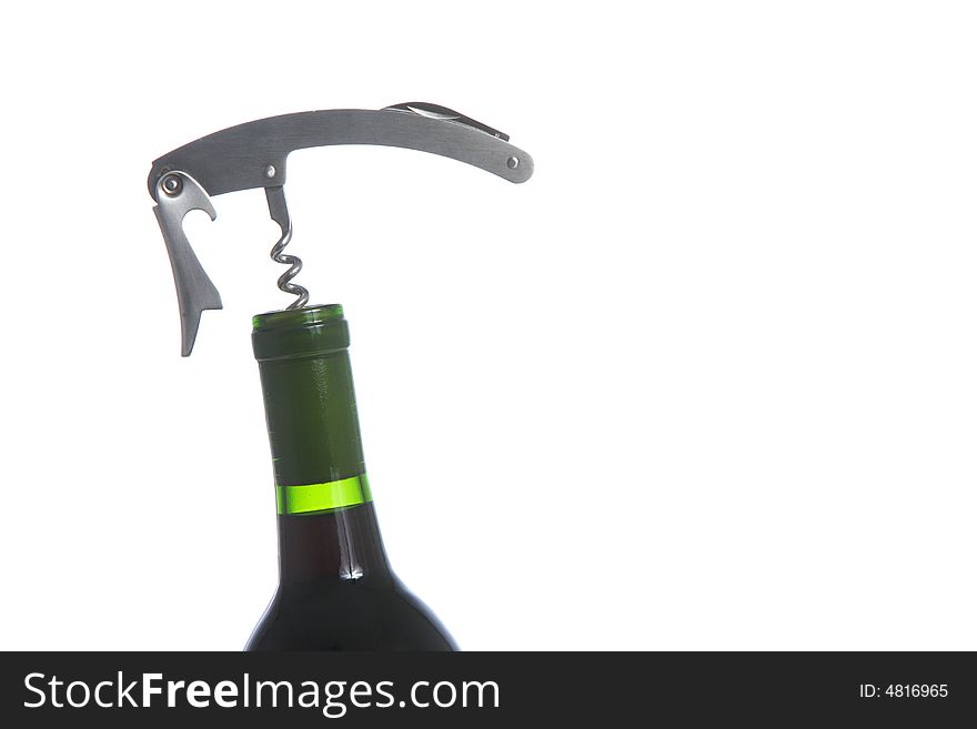 A wine opener screwed into a bottle of red wine
