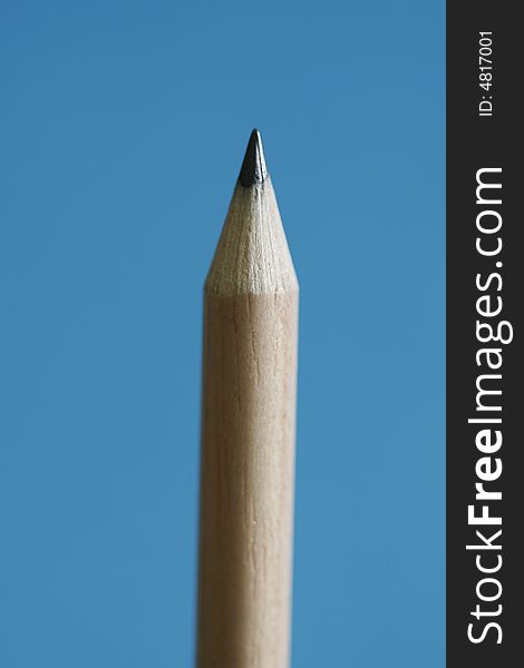 A pencil with a simple blue background