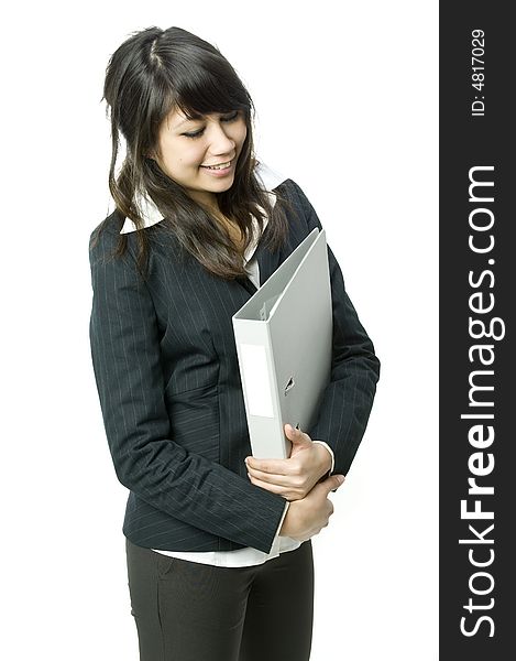 A young pretty businesswoman holding a file in the studio. A young pretty businesswoman holding a file in the studio