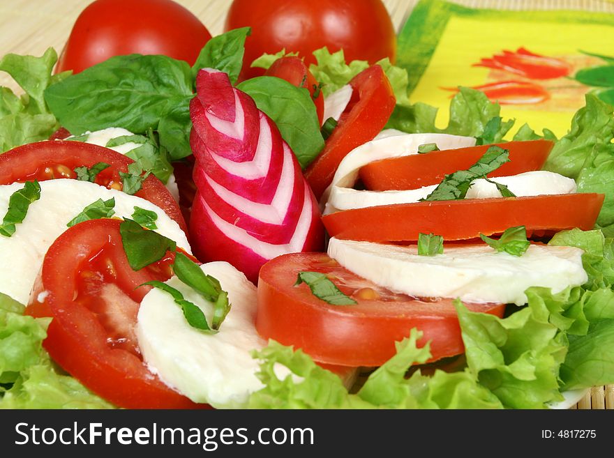 Caprese - Italian salad with tomatos, radish and mozarella cheese. Caprese - Italian salad with tomatos, radish and mozarella cheese