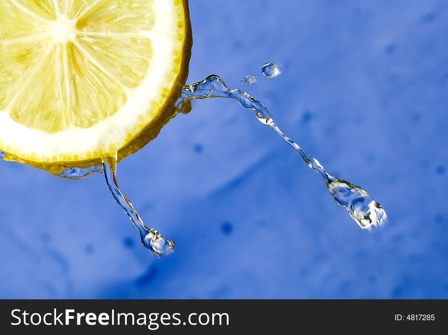 Yellow refreshing lemon against the blue background