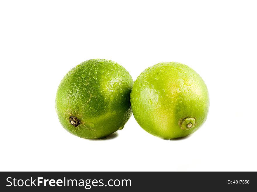 Lime fruits with water drops isolated on white background