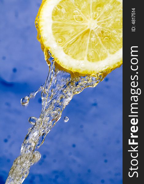 Yellow refreshing lemon against the blue background