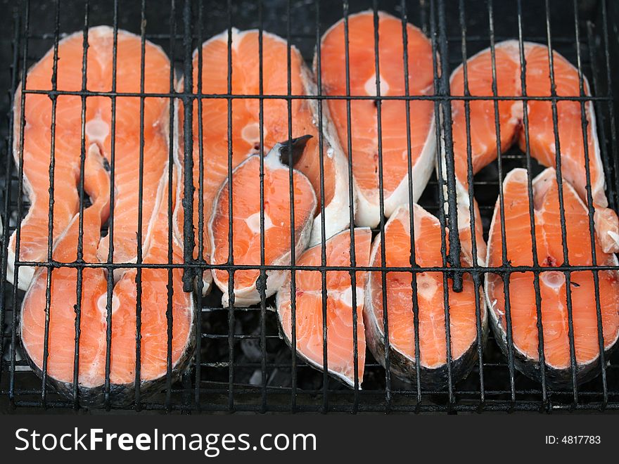 Close-up of grilled salmon pieces (background)