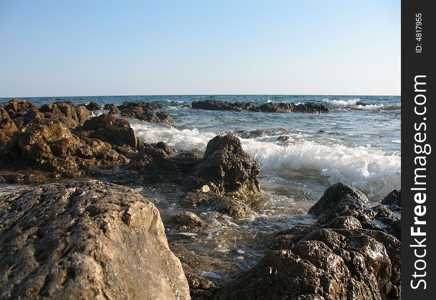 Water and rocks with little waves